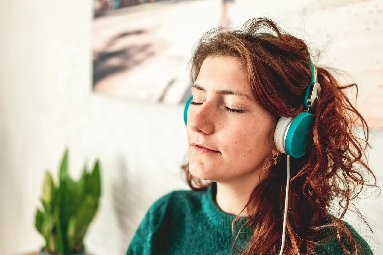 Stock photo: woman with headphones, eyes closed, relaxing at home